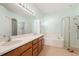Well-lit bathroom boasting double sinks, a soaking tub, and a separate glass shower enclosure at 9954 N Jasmine Brook E Cir, Land O Lakes, FL 34638