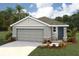 Charming single story home featuring a two car garage, stone accents, neutral paint, and tropical landscaping at 10567 Dusty Boot Rd, Land O Lakes, FL 34638