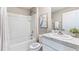 Clean bathroom with white fixtures, shower-tub combination, and a vanity with granite countertop at 10612 Dusty Boot Rd, Land O Lakes, FL 34638