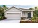 Charming single-story home featuring a two-car garage, stone accents, and meticulously landscaped front yard at 10612 Dusty Boot Rd, Land O Lakes, FL 34638