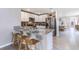 Modern kitchen with granite countertops, stainless steel appliances, and seating at the bar, adjacent to dining at 10612 Dusty Boot Rd, Land O Lakes, FL 34638