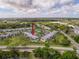 Aerial view of a complex with mature trees, a pool, and well-maintained landscaping at 110 W Cypress Ct, Oldsmar, FL 34677