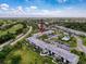 Overhead angle of community with greenery, pool, and nearby golf course at 110 W Cypress Ct, Oldsmar, FL 34677