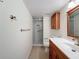 Bathroom featuring a walk-in shower, wood cabinets, large mirror, and tiled flooring at 110 W Cypress Ct, Oldsmar, FL 34677