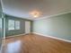 Spacious bedroom with hardwood flooring, fan, and window allowing natural light at 110 W Cypress Ct, Oldsmar, FL 34677