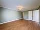 Spacious bedroom features hardwood flooring, fan, and closets for ample storage at 110 W Cypress Ct, Oldsmar, FL 34677