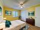 Inviting bedroom with natural light, hardwood floors, ceiling fan, and closet space for comfortable living at 110 W Cypress Ct, Oldsmar, FL 34677