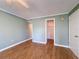 Bedroom with hardwood flooring leading to closet with custom white shelving at 110 W Cypress Ct, Oldsmar, FL 34677