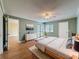 Serene bedroom showcasing a ceiling fan, sliding glass doors with a balcony, and an ensuite bathroom at 110 W Cypress Ct, Oldsmar, FL 34677