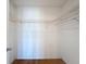 Spacious closet with hardwood flooring and custom shelving at 110 W Cypress Ct, Oldsmar, FL 34677