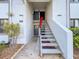 Exterior stairway leads to the front door of the condo unit at 110 W Cypress Ct, Oldsmar, FL 34677