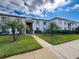 Condo building featuring manicured landscaping and palm trees for a tropical feel at 110 W Cypress Ct, Oldsmar, FL 34677