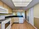 Well-lit kitchen with sleek black countertops, ample cabinet space, and modern white appliances at 110 W Cypress Ct, Oldsmar, FL 34677