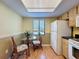 Cozy eat-in kitchen nook with glass top table and bright natural light from overhead and the window at 110 W Cypress Ct, Oldsmar, FL 34677