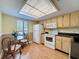 Eat-in kitchen features light cabinetry, white appliances, and plenty of natural light at 110 W Cypress Ct, Oldsmar, FL 34677