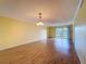 Spacious living room features light wood flooring and a sliding glass door that leads to a balcony at 110 W Cypress Ct, Oldsmar, FL 34677