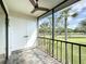 Screened in porch with ceiling fan offering fresh air and beautiful community views at 110 W Cypress Ct, Oldsmar, FL 34677