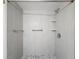 New shower with gray and white tile, river rock flooring and chrome fixtures at 110 W Cypress Ct, Oldsmar, FL 34677