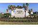 Inviting entrance to Prosperity Lakes with stone signage, a pergola, and lush landscaping at 13130 Empress Jewel Trl, Parrish, FL 34219