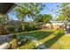 A wide backyard view features a green lawn, perimeter fencing, and multiple backyard destinations at 1543 Gentry St, Clearwater, FL 33755