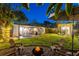 Spacious backyard featuring a fire pit, outdoor dining area, and a shed, creating an ideal space for entertaining at 1543 Gentry St, Clearwater, FL 33755