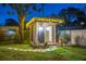 Charming backyard shed with decorative lighting and landscaping, perfect for a workshop or creative space at 1543 Gentry St, Clearwater, FL 33755