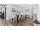 Dining room features a wooden table and white chairs with wood-look flooring at 1543 Gentry St, Clearwater, FL 33755