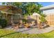 Backyard featuring a cozy fire pit area with Adirondack chairs, perfect for outdoor gatherings at 1543 Gentry St, Clearwater, FL 33755