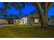 Charming home exterior with a lush lawn and mature trees, offering a welcoming and picturesque view at 1543 Gentry St, Clearwater, FL 33755