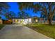 Beautiful home exterior featuring a spacious driveway, well-manicured lawn, and charming architectural details at 1543 Gentry St, Clearwater, FL 33755