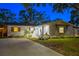 Inviting home exterior with a well-maintained lawn, front porch seating, and charming shuttered windows at 1543 Gentry St, Clearwater, FL 33755