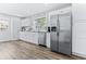 Spacious kitchen boasting stainless steel appliances, white cabinets, and granite countertops at 1543 Gentry St, Clearwater, FL 33755