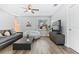 Cozy living room with modern furniture, natural light, ceiling fan and wood-look vinyl floors at 1543 Gentry St, Clearwater, FL 33755