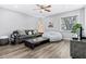 Cozy living room with modern furniture, natural light, ceiling fan and wood-look vinyl floors at 1543 Gentry St, Clearwater, FL 33755