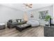 Cozy living room with modern furniture, natural light, ceiling fan and wood-look vinyl floors at 1543 Gentry St, Clearwater, FL 33755