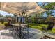 Covered patio area complete with an outdoor dining set and relaxing lounge chair in the backyard at 1543 Gentry St, Clearwater, FL 33755