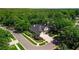 Aerial view of estate home with lush surrounding greenery at 1655 Eagles Reach, Tarpon Springs, FL 34688