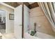 Cozy bathroom with shower, bathtub, tiled walls, and patterned wallpaper at 1655 Eagles Reach, Tarpon Springs, FL 34688