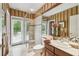 Bright bathroom featuring a glass enclosed shower and an exit to the pool at 1655 Eagles Reach, Tarpon Springs, FL 34688