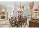 Formal dining room with a chandelier, dining table, and natural light from the shuttered window at 1655 Eagles Reach, Tarpon Springs, FL 34688