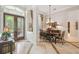 Spacious dining room with elegant chandelier, adjacent to the foyer, ideal for formal gatherings at 1655 Eagles Reach, Tarpon Springs, FL 34688