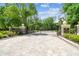 Gated community entrance with lush trees and landscaping at 1655 Eagles Reach, Tarpon Springs, FL 34688