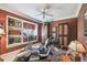 Home exercise room with treadmill, stationary bike, ceiling fan, and patterned wallpaper at 1655 Eagles Reach, Tarpon Springs, FL 34688