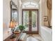 Elegant foyer featuring intricate glass double doors and a decorative console table, creating a sophisticated entrance at 1655 Eagles Reach, Tarpon Springs, FL 34688