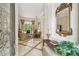 Inviting foyer showcases a glimpse of the living room with a view to the outside, plus a decorative mirror at 1655 Eagles Reach, Tarpon Springs, FL 34688