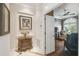Inviting hallway leading to living area with a decorative cabinet and view of an arch window at 1655 Eagles Reach, Tarpon Springs, FL 34688