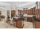 Spacious kitchen boasts custom cabinets, a large island, granite counters, and modern stainless steel appliances at 1655 Eagles Reach, Tarpon Springs, FL 34688