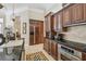 Spacious kitchen featuring dark wood cabinetry, black granite countertops, and modern appliances at 1655 Eagles Reach, Tarpon Springs, FL 34688