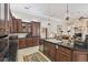 Spacious kitchen featuring dark wood cabinetry, black granite countertops, and an island with sink at 1655 Eagles Reach, Tarpon Springs, FL 34688