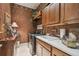 Inviting laundry room with dark wood cabinets, tile floors, modern washer and dryer at 1655 Eagles Reach, Tarpon Springs, FL 34688